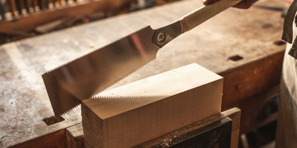 Double edged Japanese pull saw on a wooden workbench