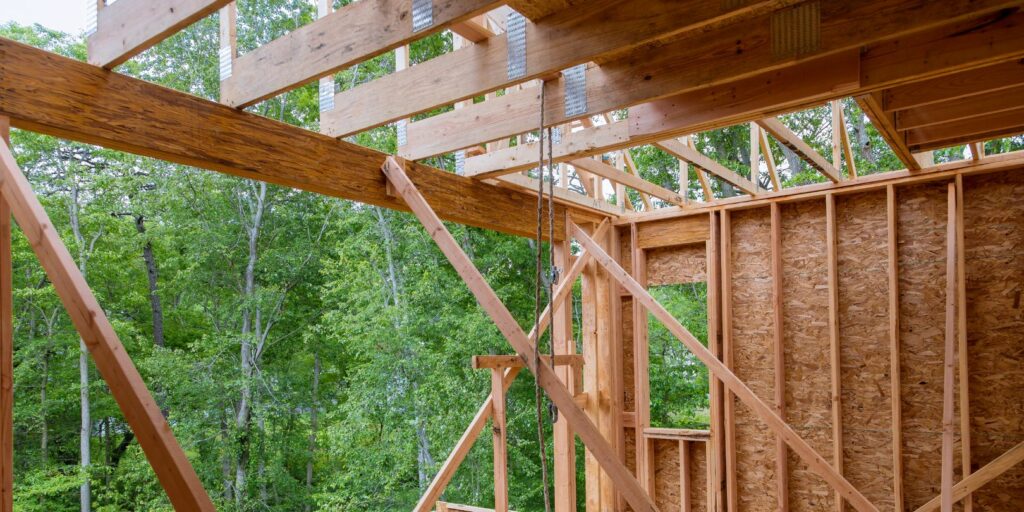 The newly constructed stick house is made of timber beams and truss frames.