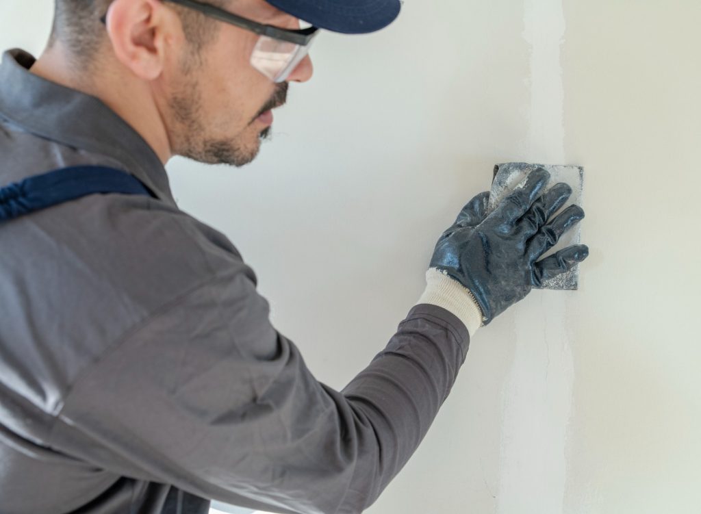 Man sanding drywall